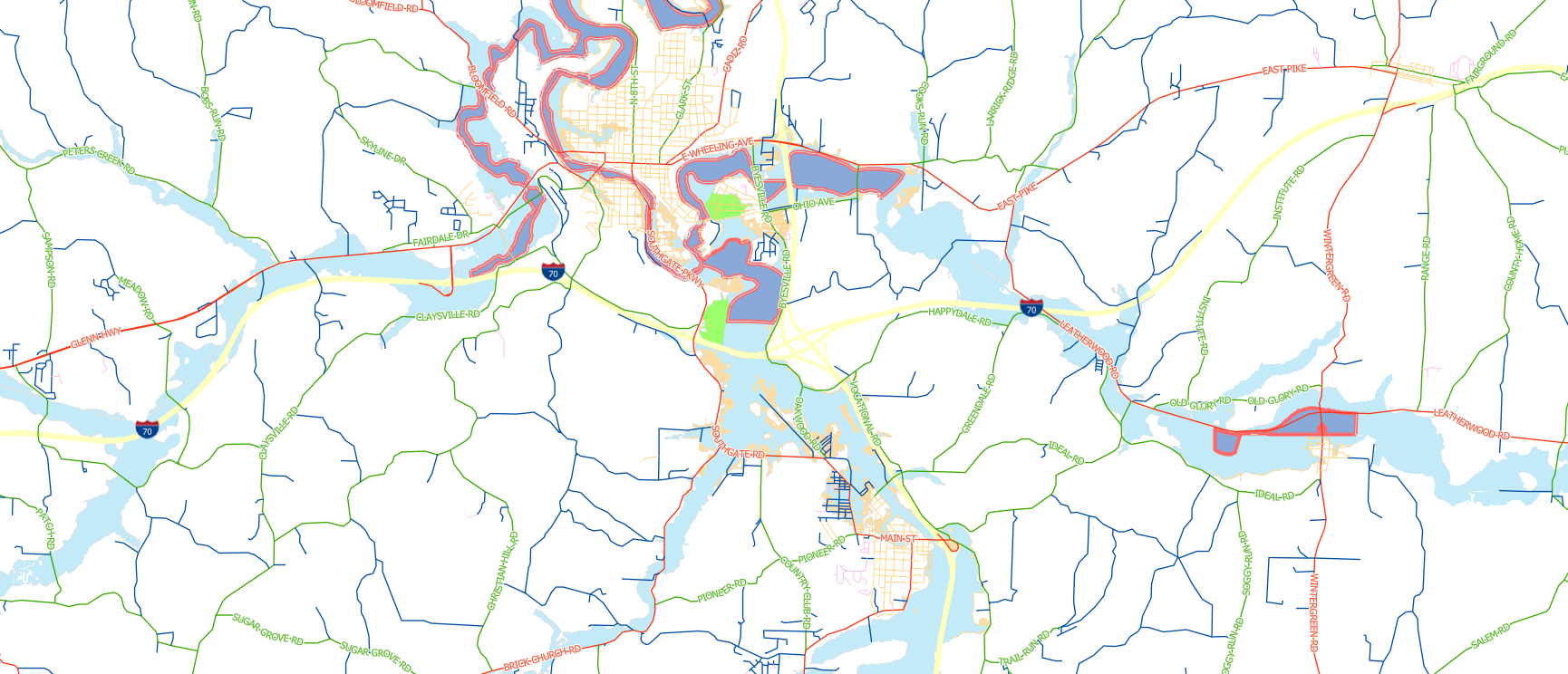Map showing roads, highways, rivers, lakes, and city layouts in a geographic area. Red, yellow, and green lines mark major and minor roads; blue lines mark water features; shaded areas indicate cities and bodies of water.